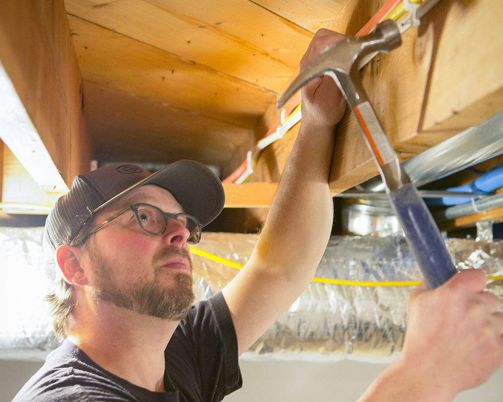 man using hammer west bend wi