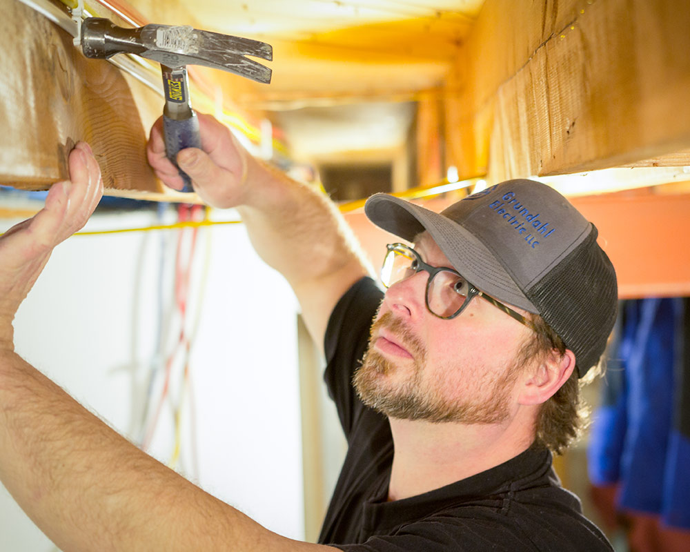electrician using hammer newburg wi