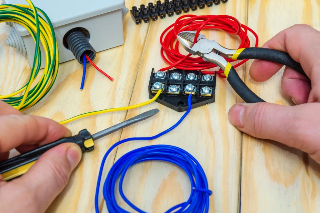 the master holds an electric tools and wires to connect photo 1
